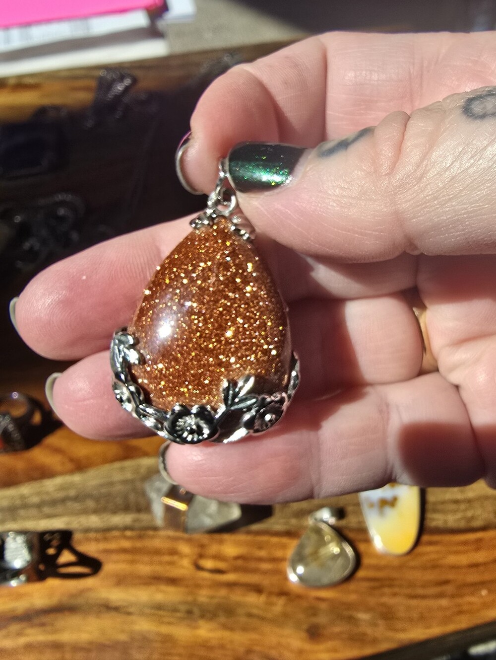 Glittering Flower Wrapped Goldstone Pendant